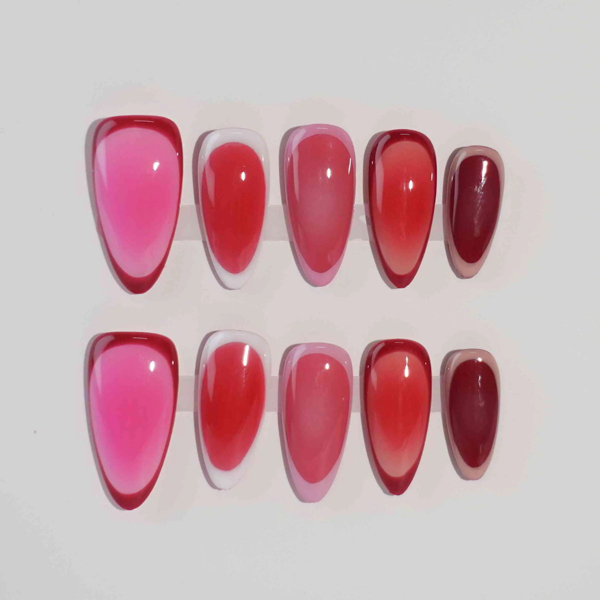 Gradient pink almond press on nails with seamless ombré from soft rose to bold ruby.