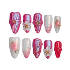 Ombré pink almond press on nails with pearl sheen and 3D floral embellishments.