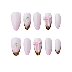 Elegant pink almond press on nails with bows and animal print design.