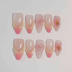 Soft pink almond press on nails featuring cherry blossom floral accents, perfect for spring.