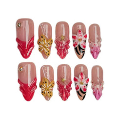 Pink and red flame tip almond press on nails with gold butterflies and orchid flowers.