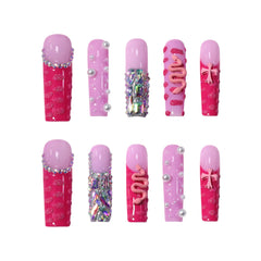 Extra long coffin-shaped pink press-on nails featuring rhinestones, 3D bows, pearls, and glitter snake art on hot and pastel pink bases
