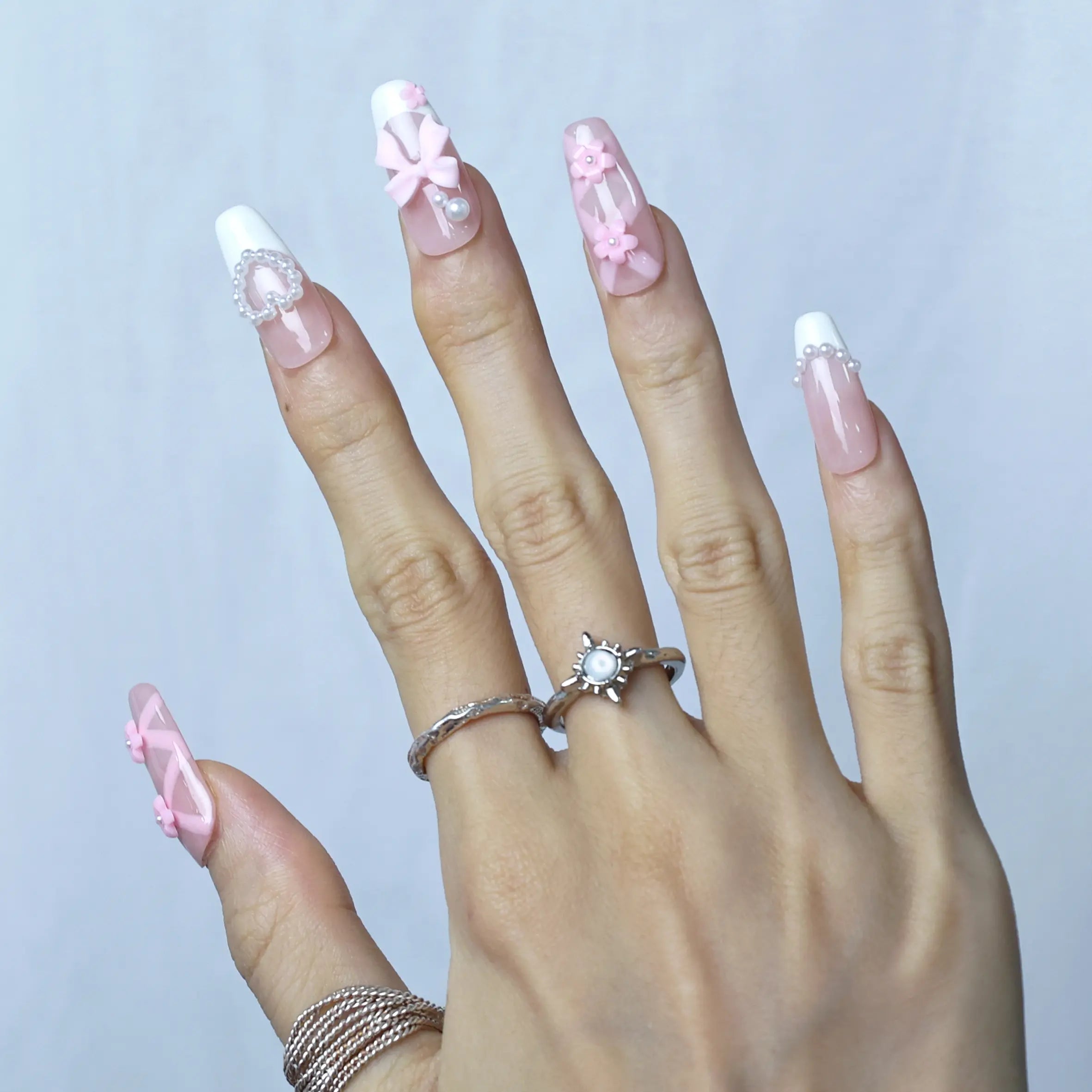 Side view of pink coffin nails with handcrafted 3D blossoms and subtle pearl sparkle