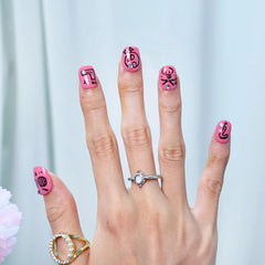 Quirky nail art press-ons in hot pink with accents