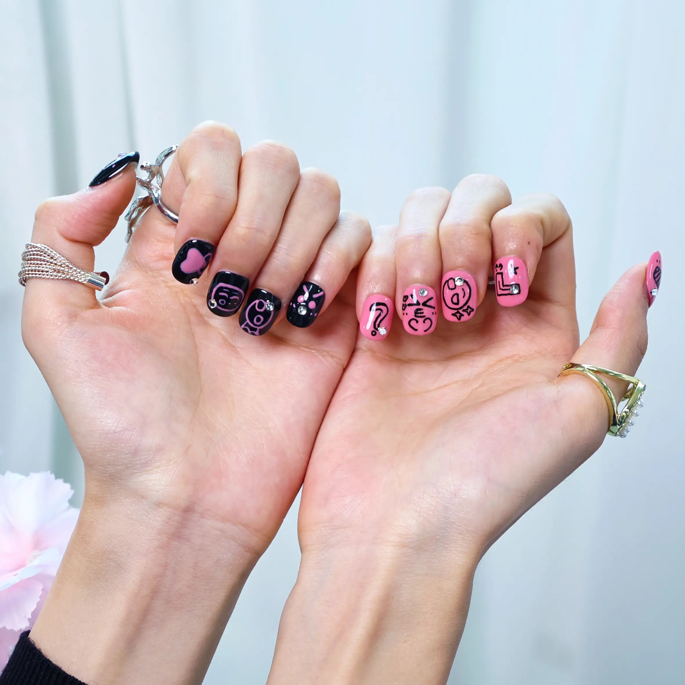 Styled hand wearing vibrant funky pink squoral press-ons