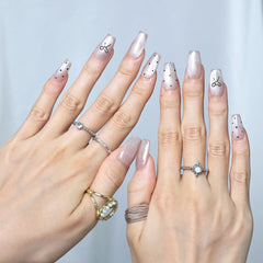 Hand pose showcasing feminine polka-dot press-on nails