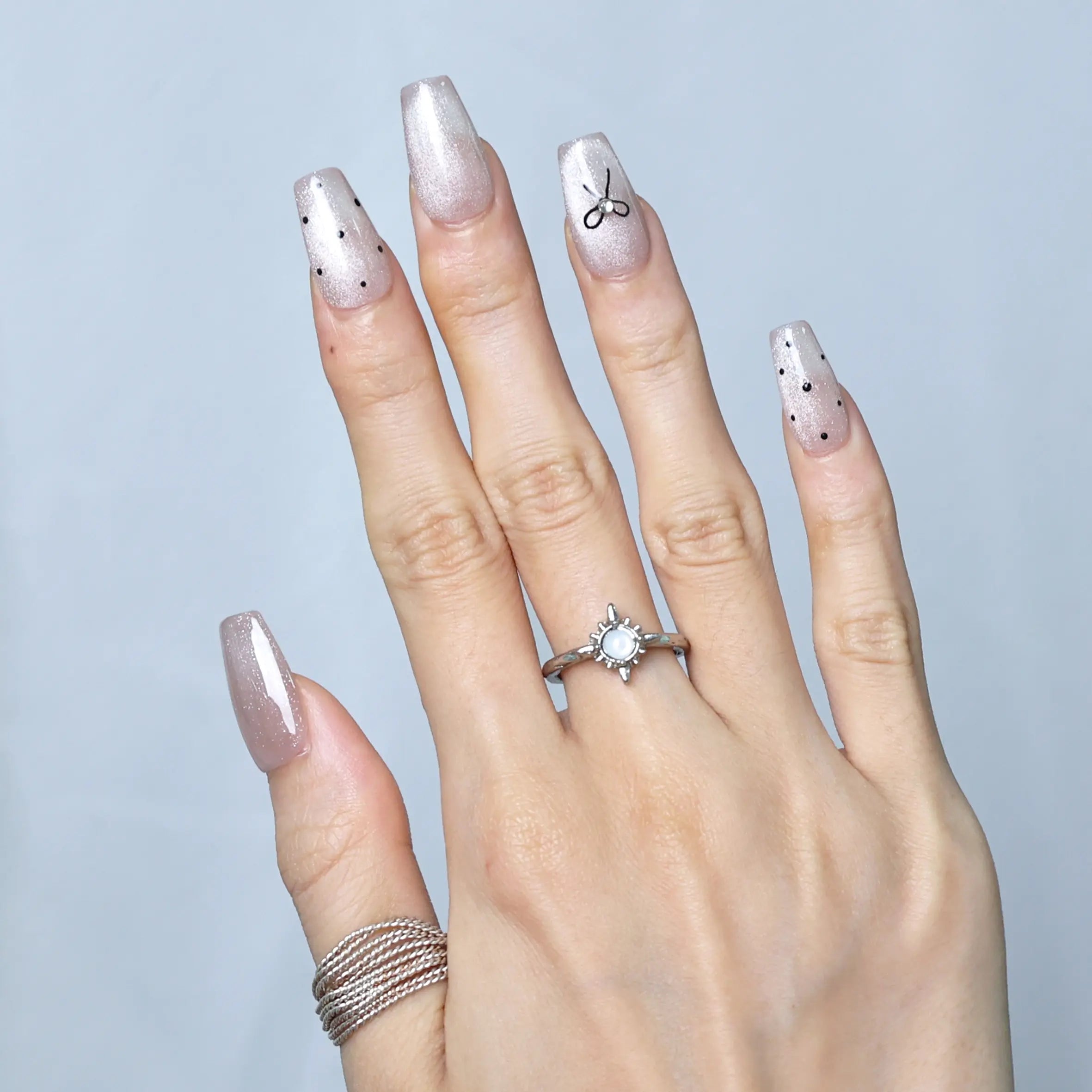 Styled look with playful dots and soft pink tones