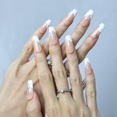 Close-up of astrology-themed nails featuring minimalist symbols and celestial shimmer