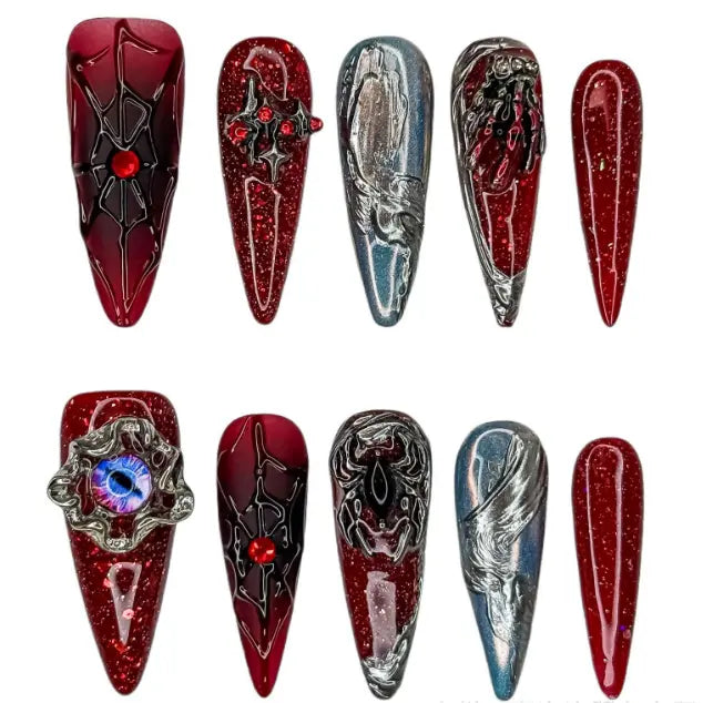 Long stiletto red press on nails with ombré, chrome finish, and rose details.