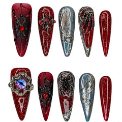Long stiletto red press on nails with ombré, chrome finish, and rose details.