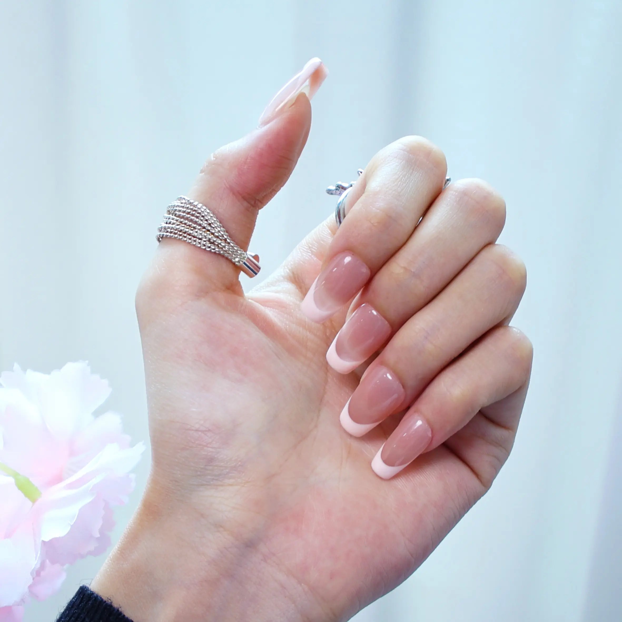 Medium-length squoval press-ons in rose-pink tip design