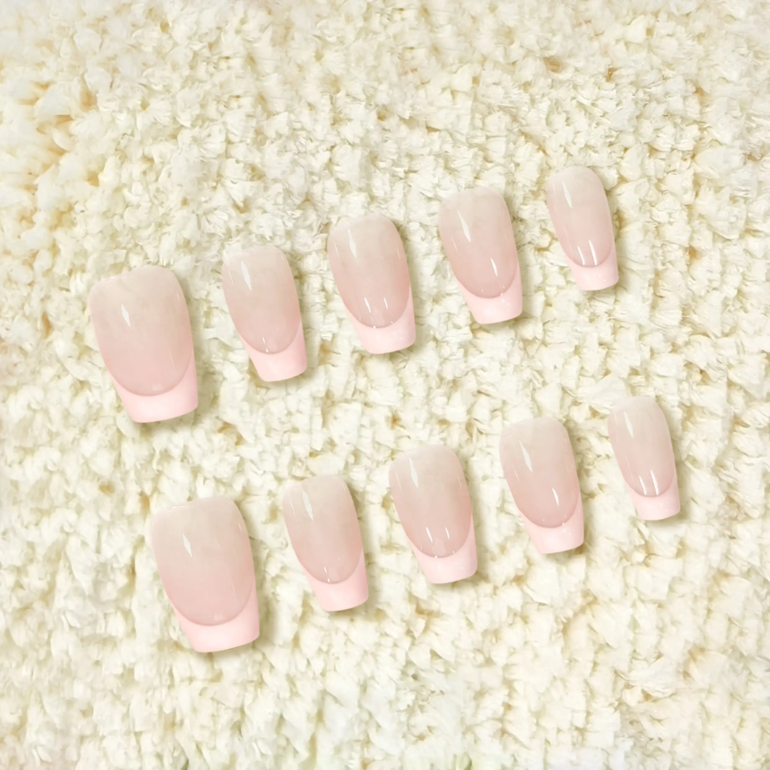 Product display of pink French tips with soft gradient