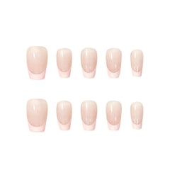 Handmade press-on nails with nude base and soft pink French tips in a modern, romantic style. Ideal for weddings, daily wear, or special occasions