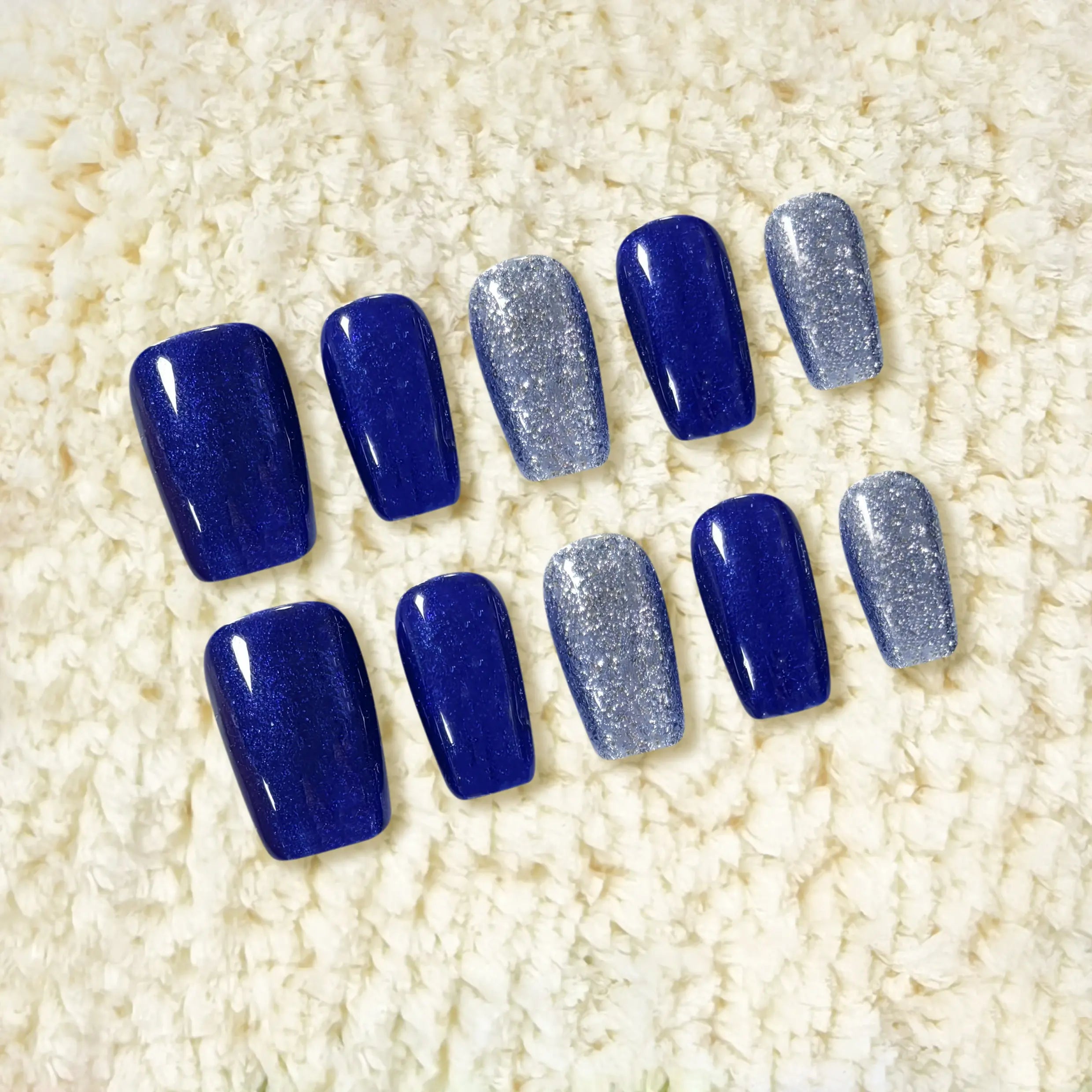 Medium squoval blue press on nails with royal blue base and silver glitter accents