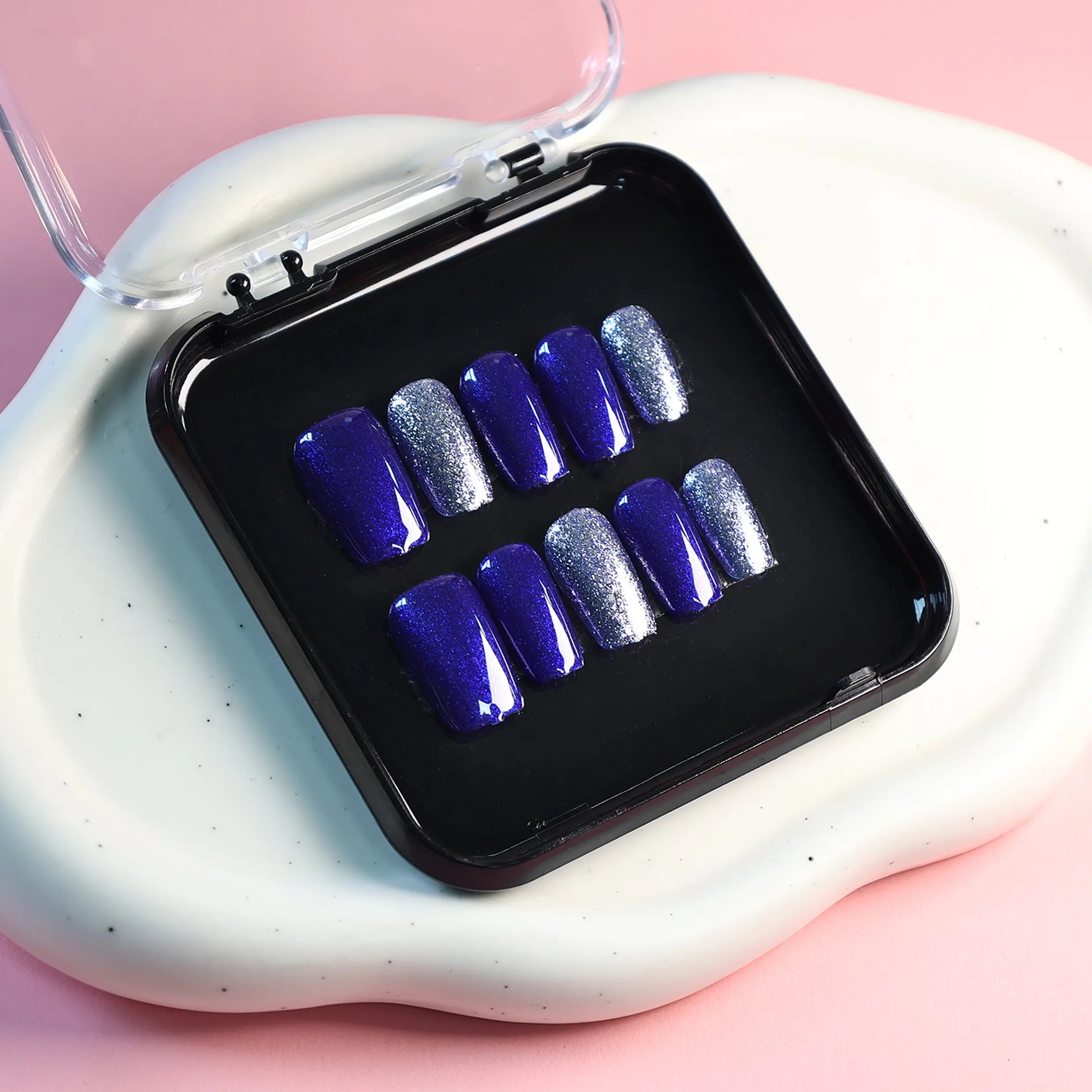 Full nail set display featuring royal blue nails with silver glitter arranged in box