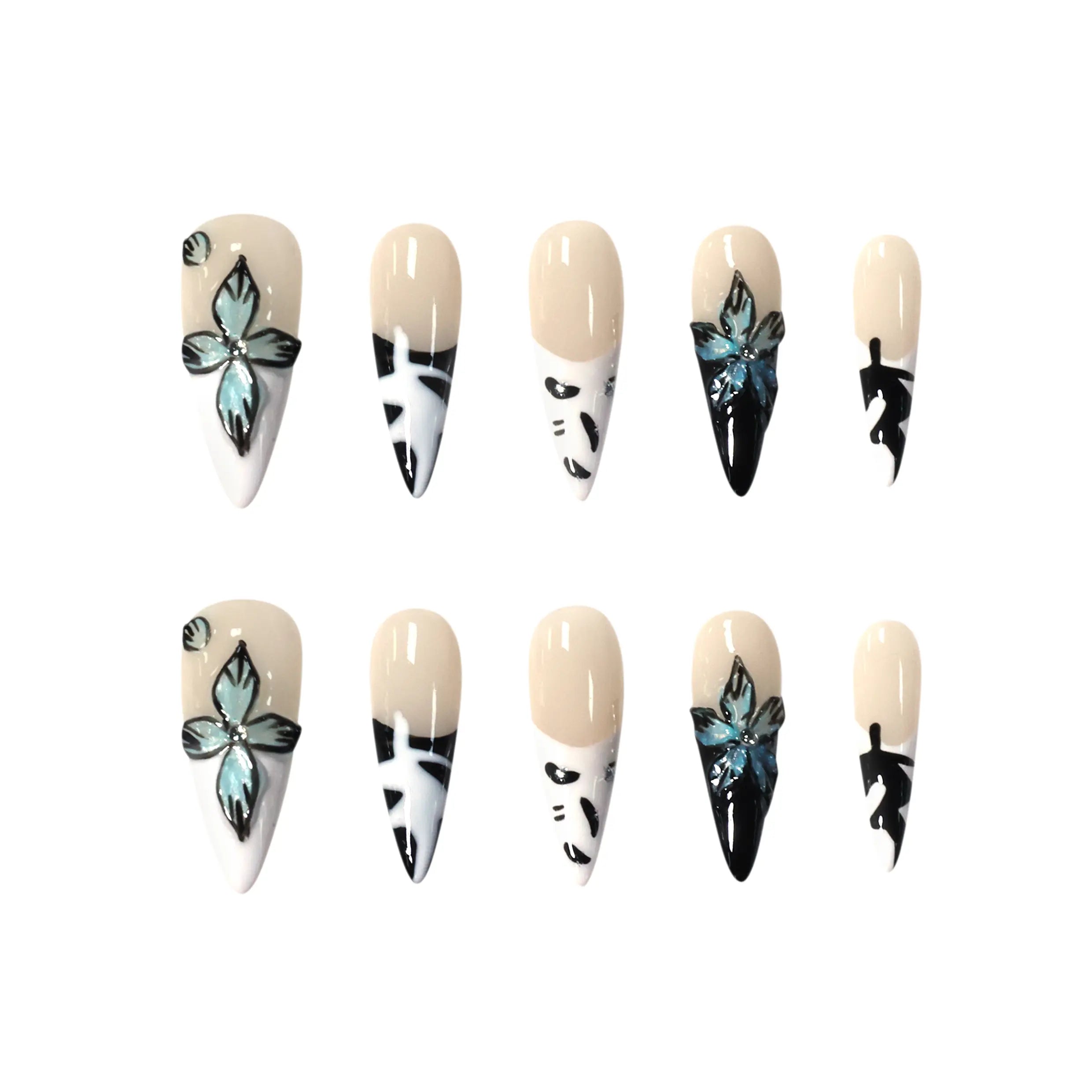 Long stiletto press-on nails with black and white abstract designs, floral crystals, and a glossy nude base.