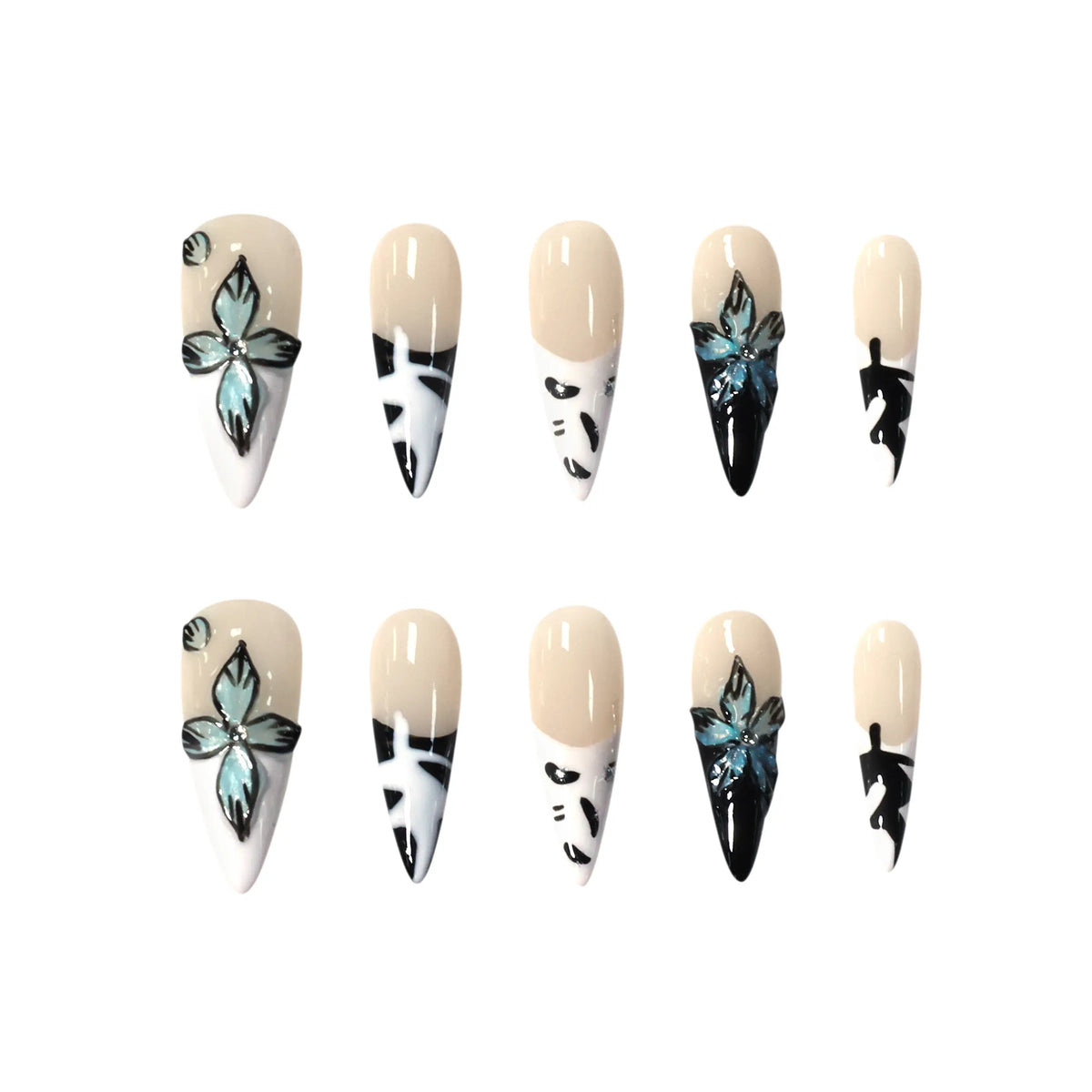 Long stiletto press-on nails with black and white abstract designs, floral crystals, and a glossy nude base.