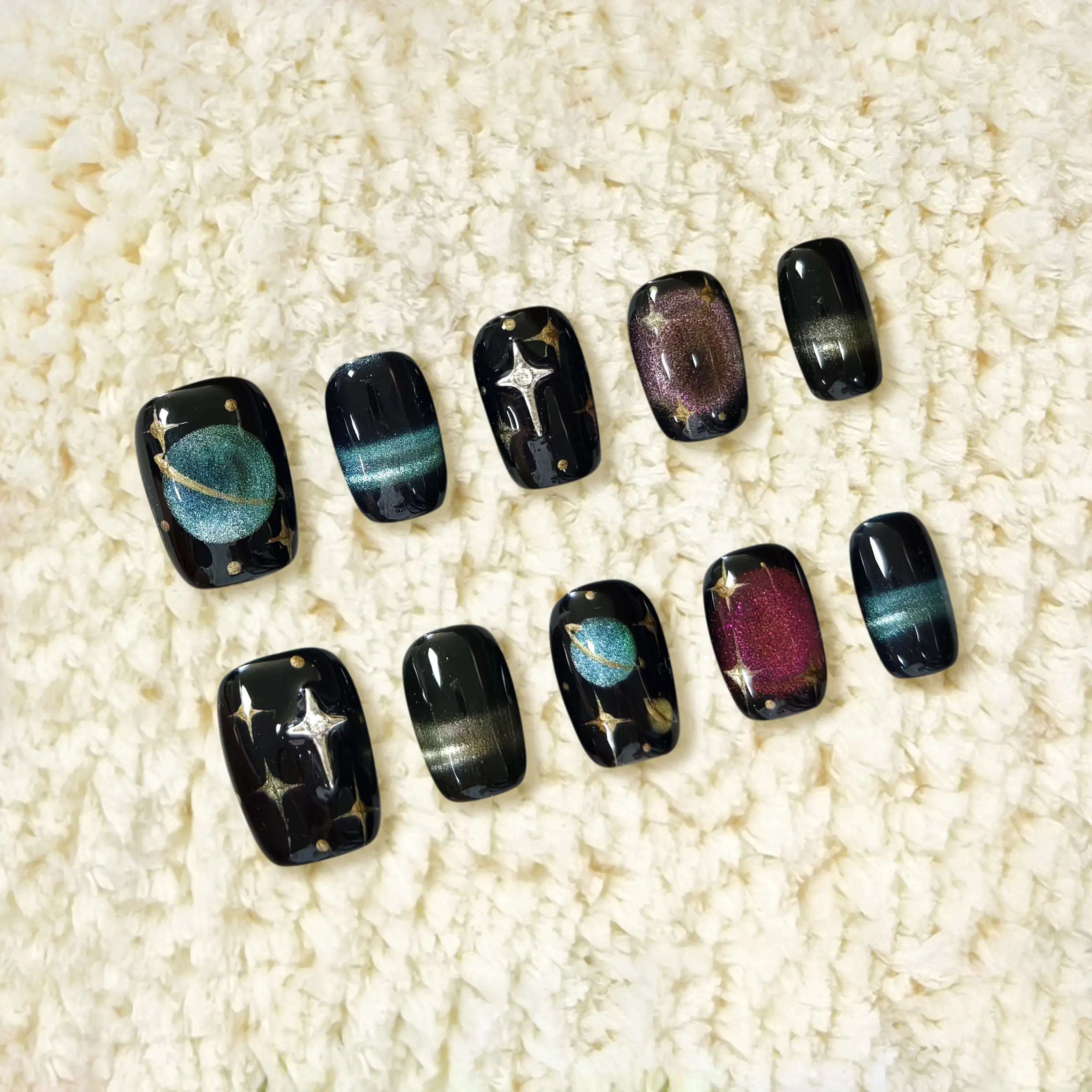 Full nail set with celestial patterns and magnetic polish