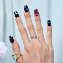 Cat-eye black nails with galaxy shimmer and pink aura
