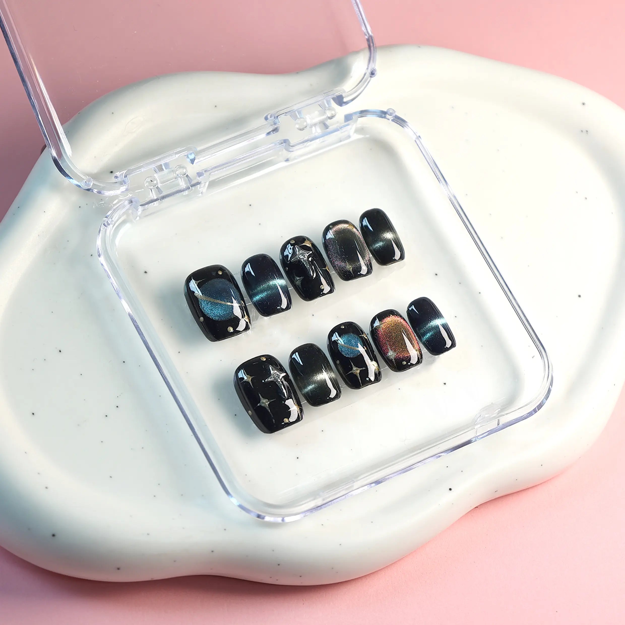 Dark-themed press-on nails displayed with galactic background