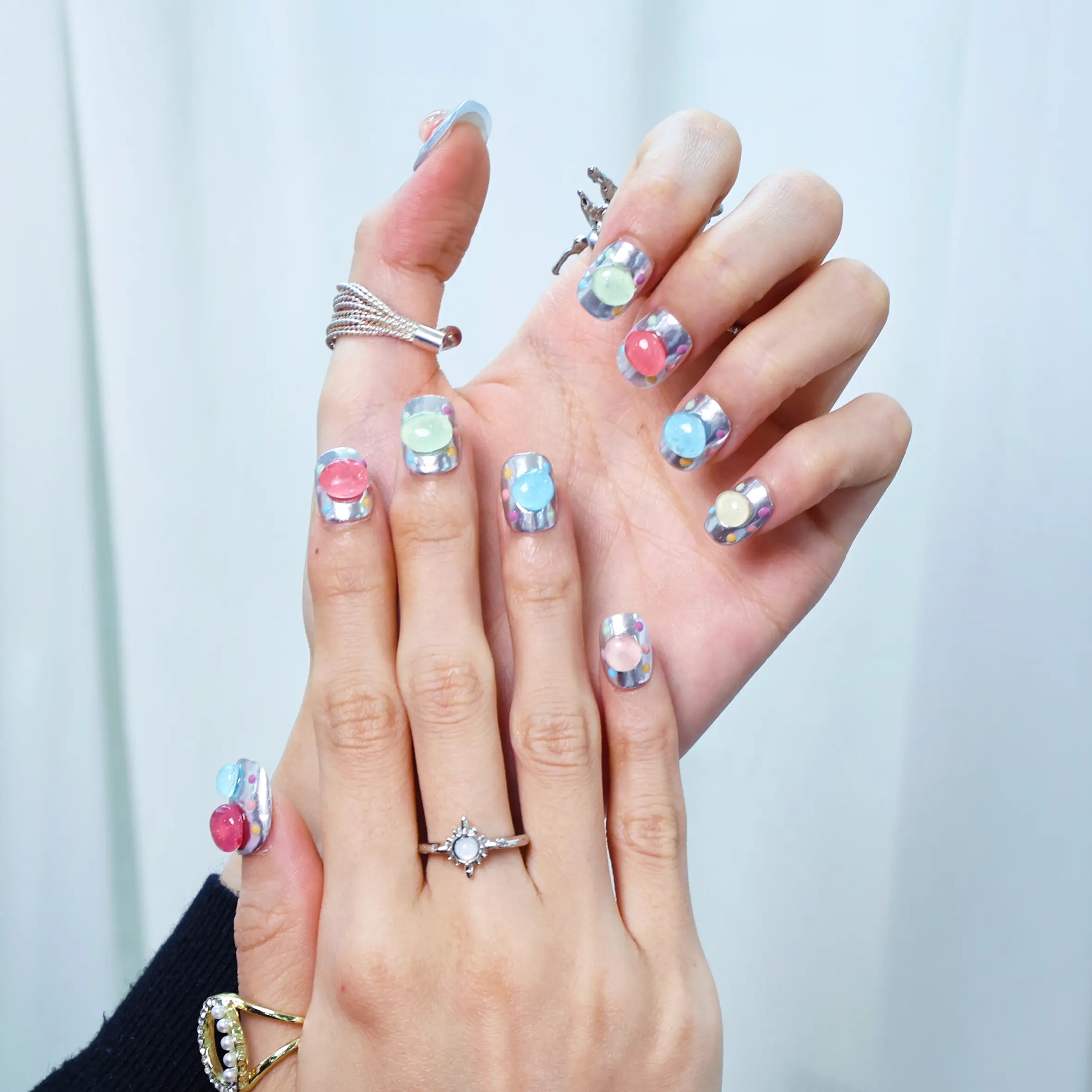 Hand wearing pastel candy bubble nails with a playful pop look