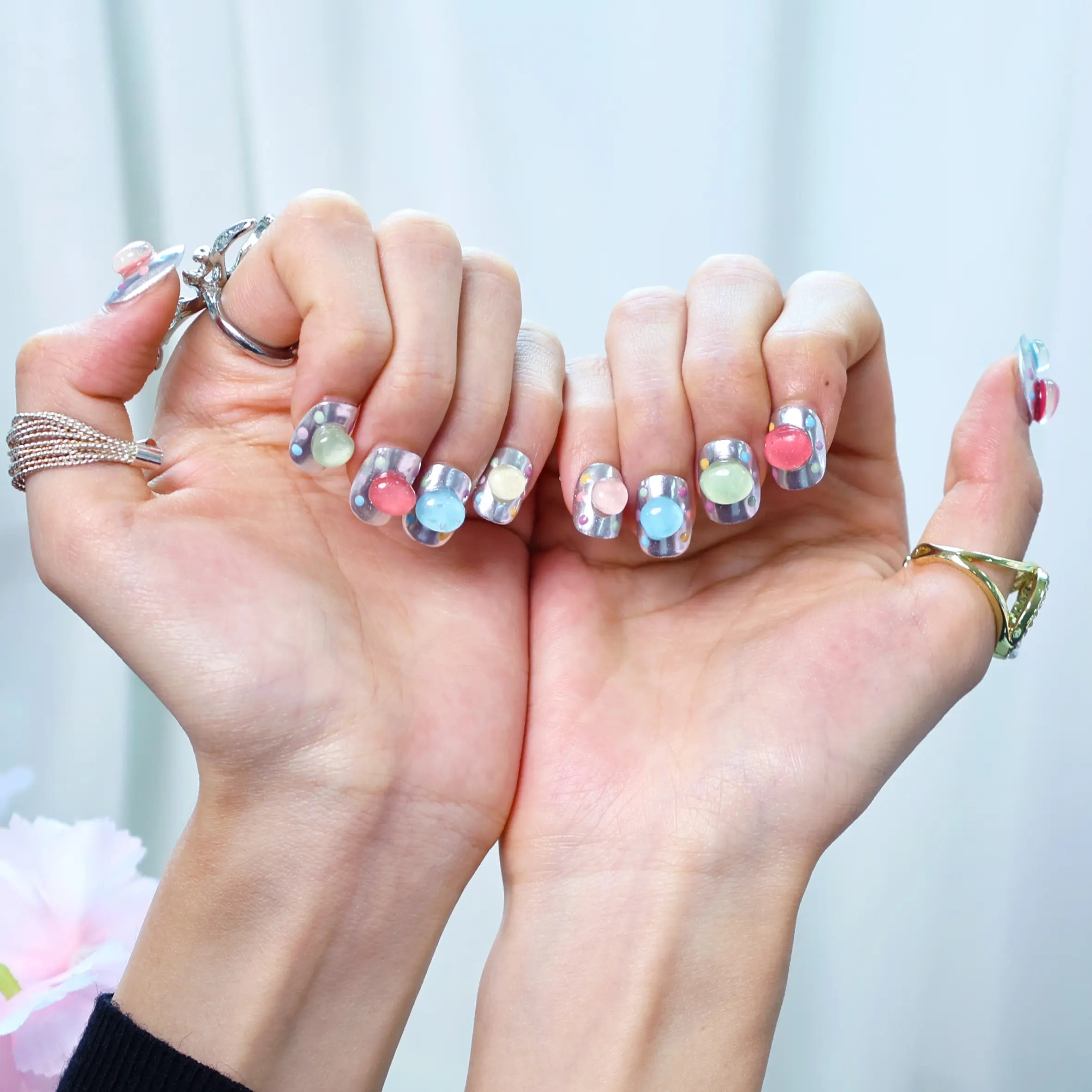 Lifestyle image of hands with pastel press-on bubble nails