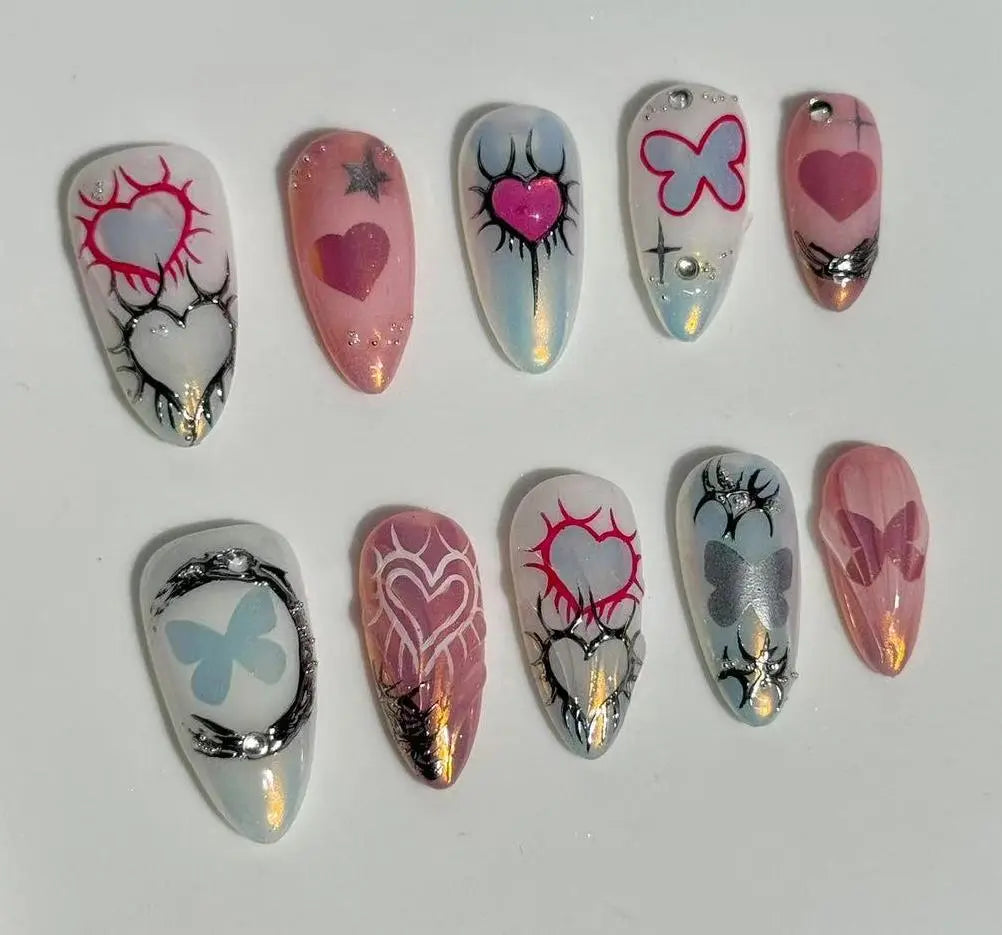 Chrome-finish pink almond press on nails with candy heart details and glitter edges.