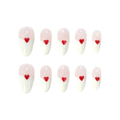 Pink almond press-on nails with red heart accents and a diagonal pink-and-white base for a romantic, feminine look.