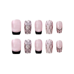 French tip press on nails in blush and black with grid design and bear accent, medium squoval shape.