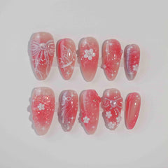 Pink and red ombré almond press-on nails with 3D cherry blossoms, sparkles, and tiny bow accents—romantic and handmade.